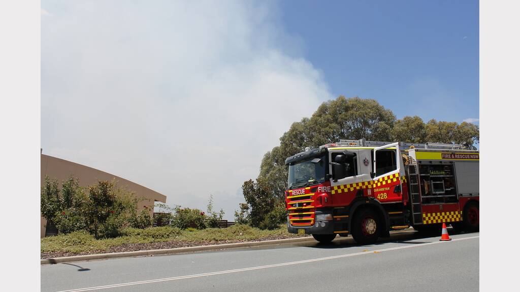Firefighters are protecting homes from a bushfire burning in Jerrabomberra (PHOTOS: David Butler, Queanbeyan Age).