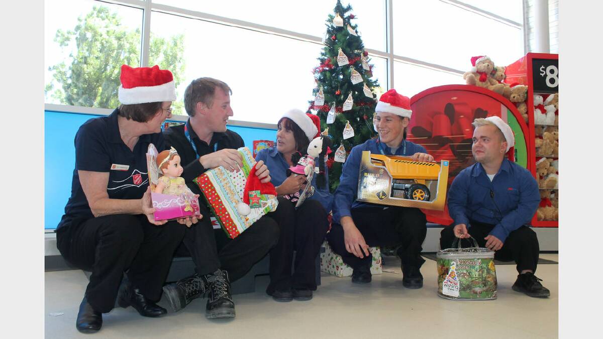 Salvation Army Major Debbie Hindle, Kmart store manager Michael Ogley and Kmart employees Theresa Enslow, Zack Enslow and Nathan Smith check out some of the gifts donated to this year's Wishing Tree. Photo: Andrew Johnston