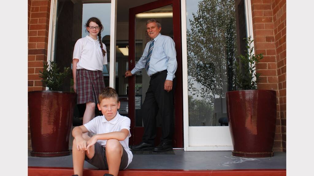 School's in: New year seven students Ella Buckley and Anthony Winchester with Queanbeyan Principal John Clark. (Photo: David Butler.)
