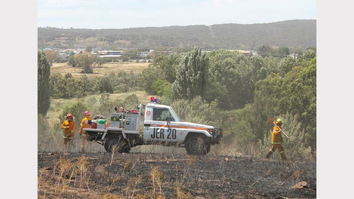 Local firefighters extinguish a blaze opposite Oaks Estate on Tuesday as hostile weather conditions battered the region.