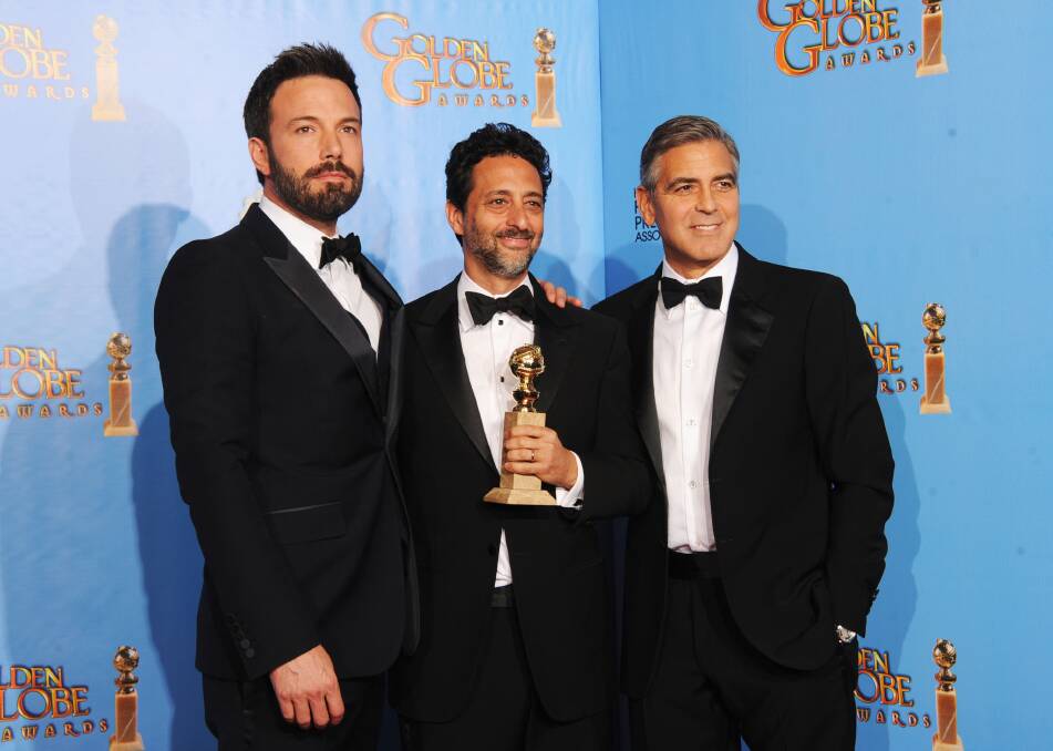 Actor-director Ben Affleck, producer Grant Heslov and producer George Clooney, winners of Best Motion Picture (Drama) for 'Argo'. Photo by Kevin Winter/Getty Images