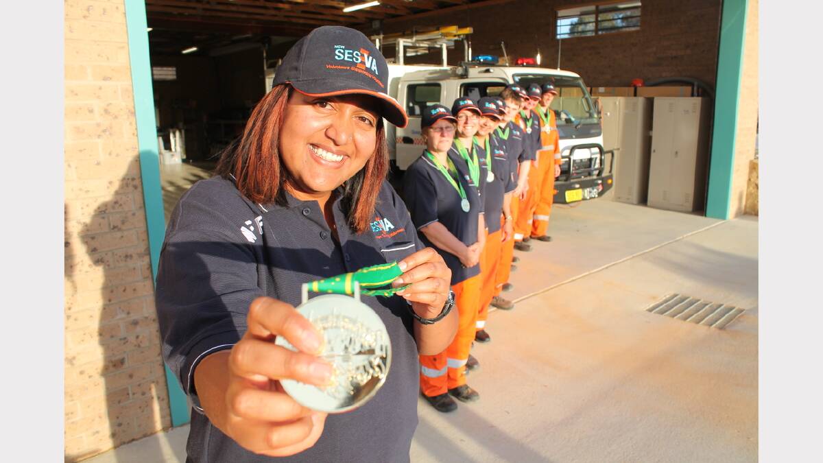 Zakia Patel with fellow Queanbeyan SES volunteers and their swag of medals.