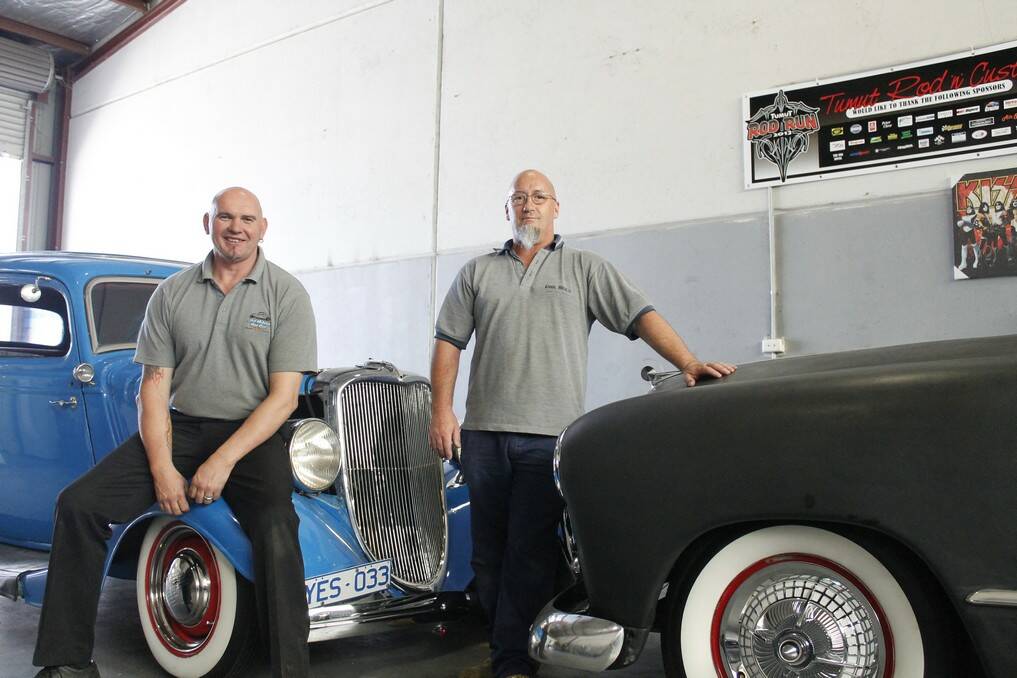 Canberra Hot Rod Association president John Thompson (left) atop his 1933 Ford Tudor hot rod and Todd Bevan with his black 1949 Ford.
