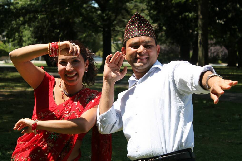 Anjana Khaniya wearing a sari and Yudaraj Khaniya wearing a traditional Nepali hat, a topi were scheduled to perform at the Carnivale Multicutural Festival but it was rained out.