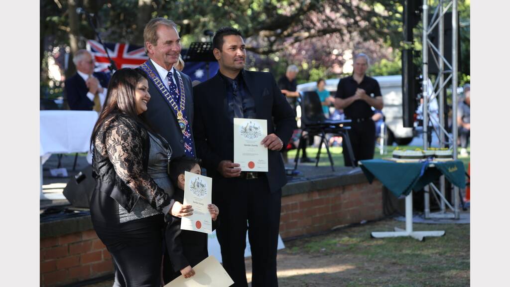 New Australian Citizens accept their official certificates.