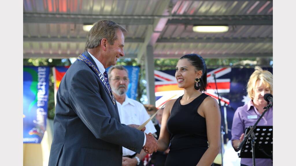 New Australian Citizens accept their official certificates.