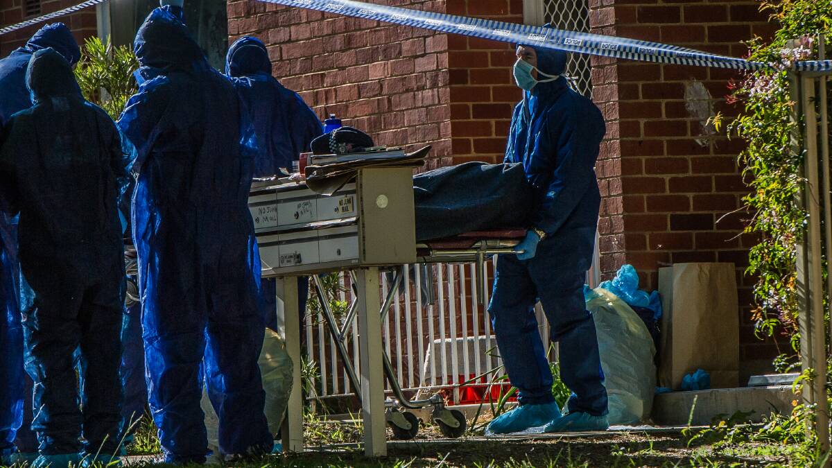 CRIME: Police remove the body from a block of flats in Windeyer street Watson in November last year. Photo: Karleen Minney