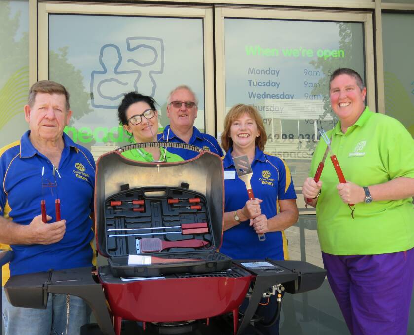 DONATION WELCOMED: Members of the Rotary Club of Queanbeyan with Headspace workers in Queanbeyan, pictured with their new barbecue.