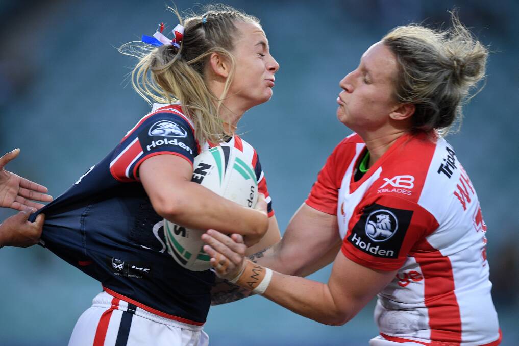 Holli Wheeler blocks the path of a Sydney Roosters player during a clash in 2018 NRLW competition.