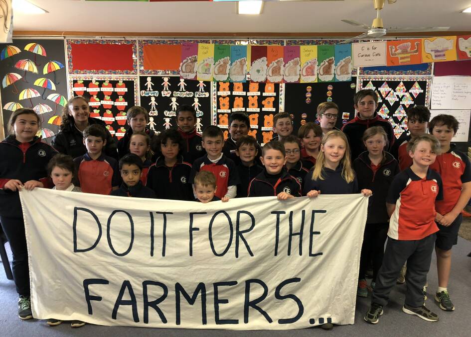 Students from Queanbeyan East Public School showing their support for farmers suffering through the drought.