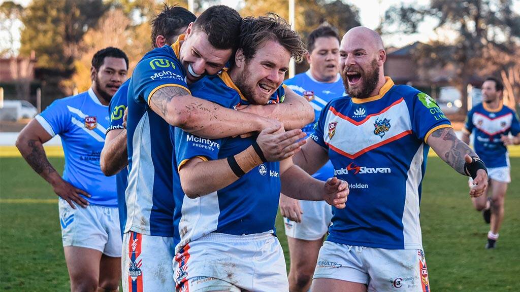 Tuggeranong Bushrangers rush in for a team celebration in the aftermath of securing a try. Photo: Jon Kroiter