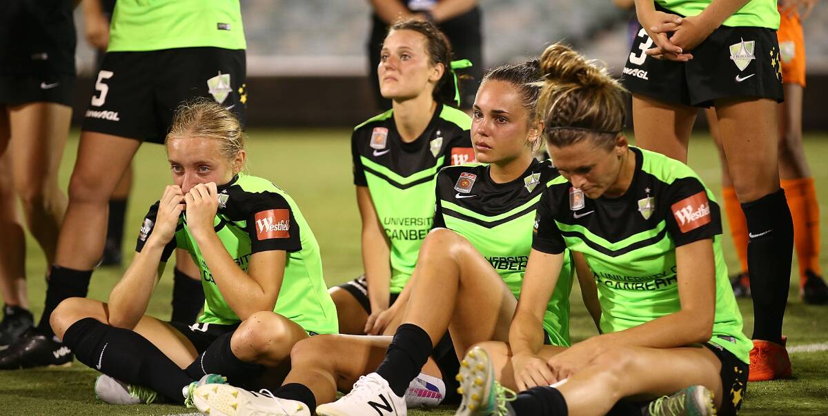 TOUGH LOSS: Canberra United players dejected after their extra-time loss on Sunday. Photo: Mark Metcalfe/Getty Images.