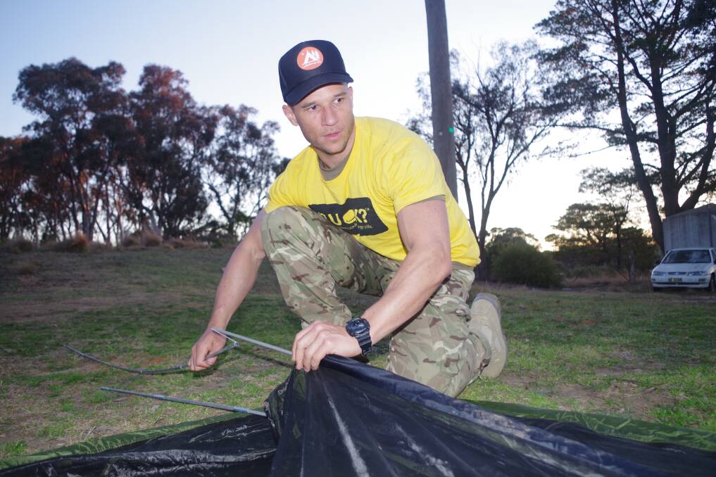 R U OK DAY: Warren Leppam setting up his tent at the Governors Hill Caravan Park on R U OK Day part way through his fundraising walk to Canberra.