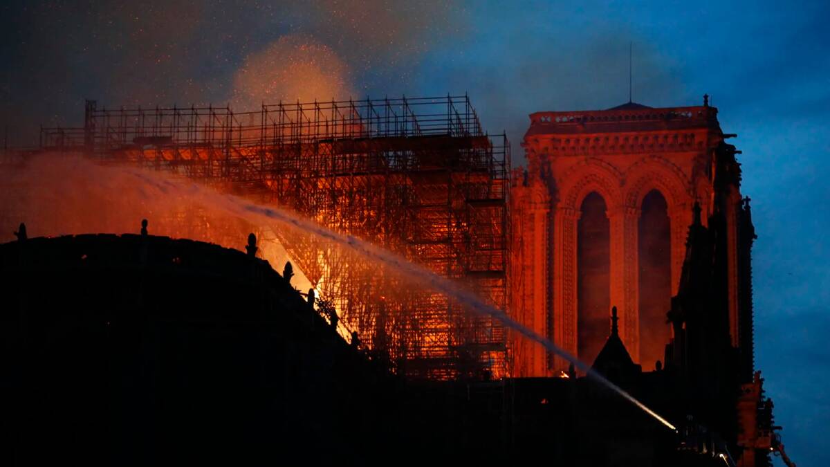 Firefighters use hoses as Notre Dame cathedral burns in Paris.