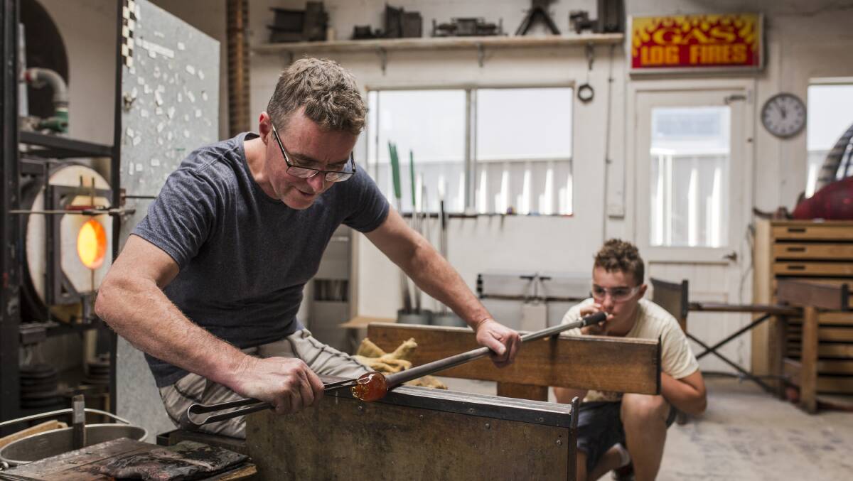 Matt Curtis from Curtis Glass Art Studio is assisted by son Hugo during the Arts Trail. Photo: Jamila Toderas