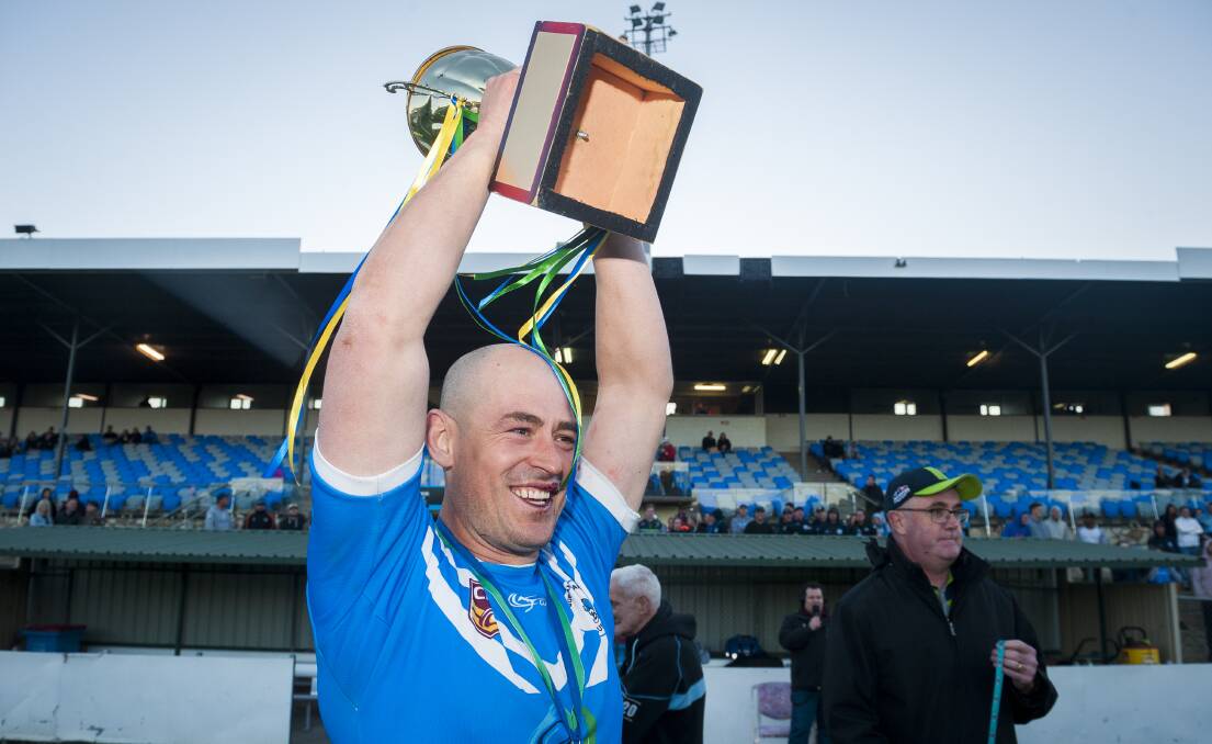 Terry Campese lifts the trophy after claiming victory over the Queanbeyan Kangaroos in the championship decider. Photo: Dion Georgopoulos