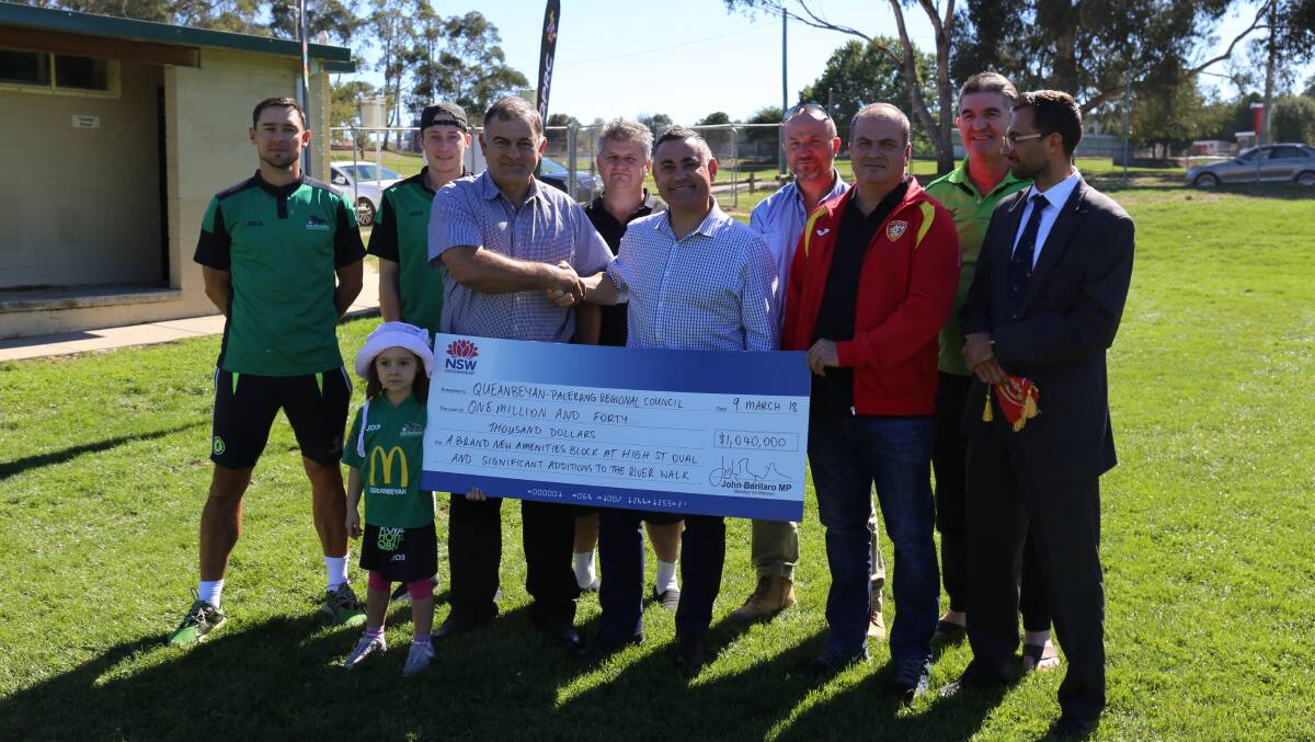 Deputy Premier John Barilaro presents Deputy Mayor Trevor Hicks with a cheque with representatives from Monaro Panthers and Queanbeyan City FC. Photo: Supplied