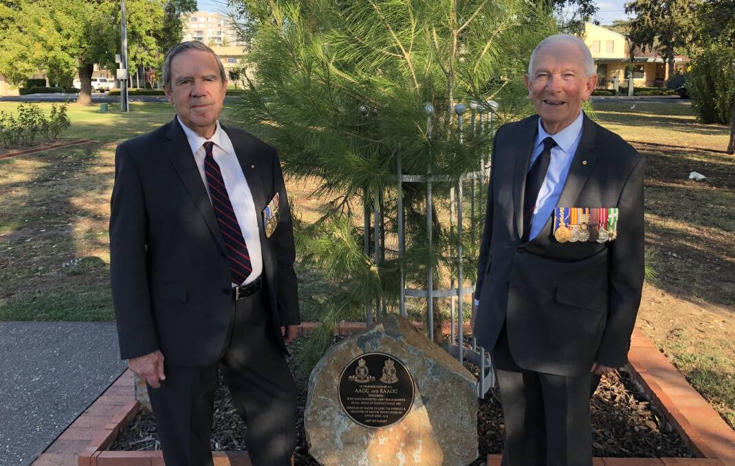 Ian Wills and Peter Bray AM with the plaque dedicated to the Royal Australian Army Ordnance Corps at the Queanbeyan Memorial Rose Garden. Photo: Elliot Williams