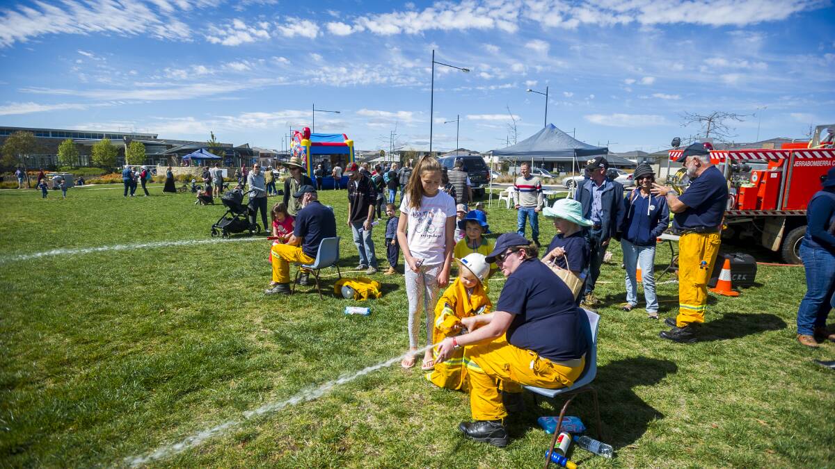 Fun in the sun: Members of the Jerrabomberra Creek Rural Fire Service were training up the next generation of firefighters at the open day in Beltana Park, Googong. Photo: Dion Georgopoulos