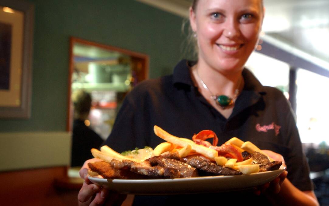 The mixed grill, held by waitress Kristie Cooper, was a challenge for many customers over the years. Photo: Marina Neil