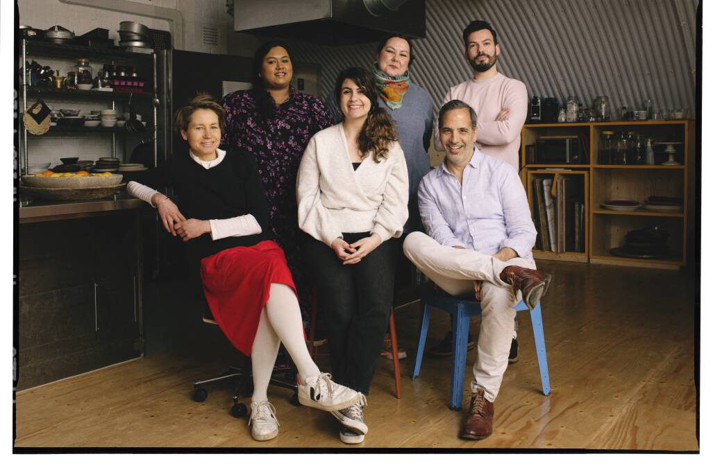 Clockwise from above: Noor Murad, centre front, and Yotam Ottolenghi and the team from the test kitchen. Picture: Elena Heatherwick