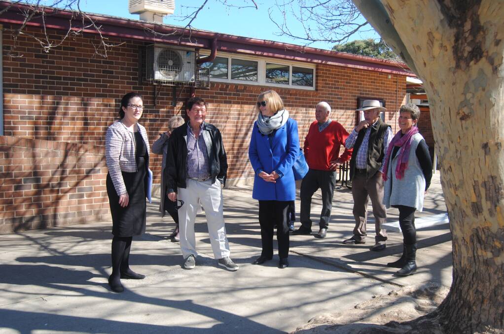 Getting a tour: QHS principal Jennifer Green shows the 1959 students around the school.