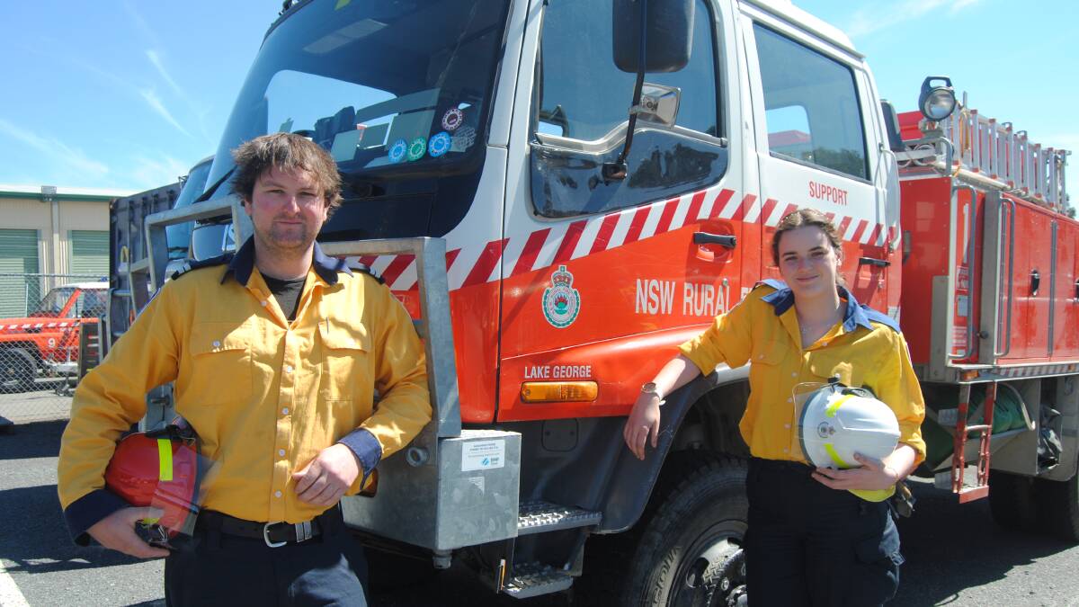 Back home: RFS volunteers Liam MacWilliam and Jess Love flew to Queensland last week to help fight fires in the Gold Coast hinterland. Photo by Phil Mayne.