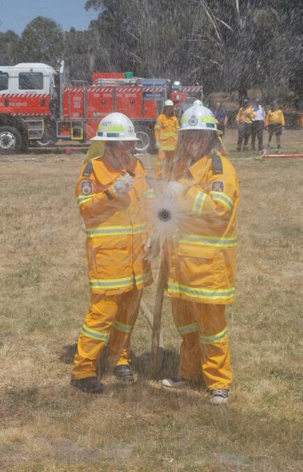 Gotcha!: Kiara Sliwinski, 15, from Googong, left, and Zara Lawson, 14, from Karabar, open up the fog setting to provide protection from a gas fire. Both are students at Queanbeyan High School.