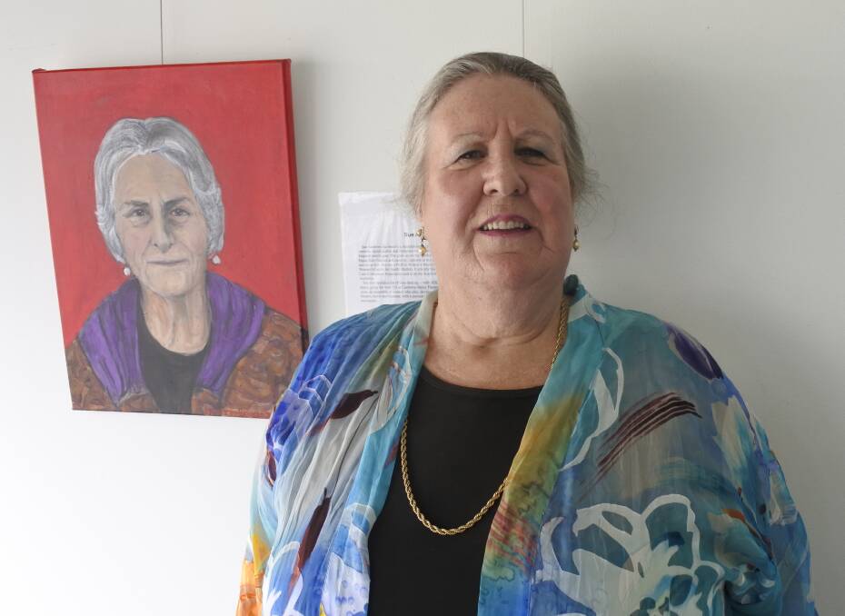 Work on show: Artist Julie McCarron-Benson with one of her 19 portraits that she has painted as part of a new exhibition at Canberra Artworks Gallery. Photo: Andrew Brown