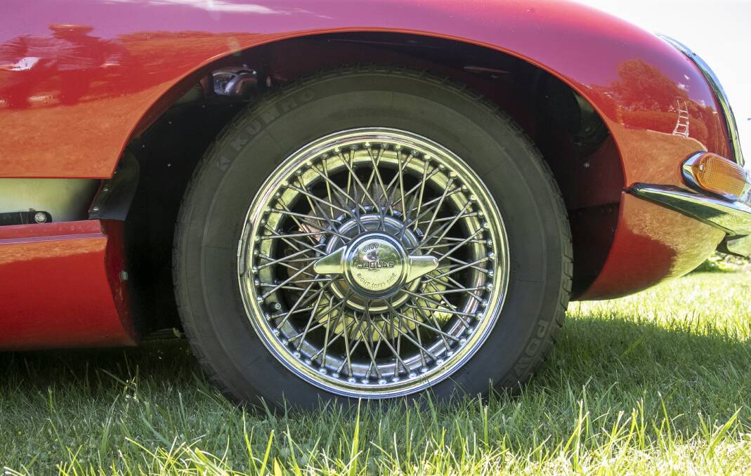 The E-type's chrome wire wheels, with racing-type single "knock-off" nut, encompassed four-wheel disc brakes, rare for the time. Picture: Keegan Carroll