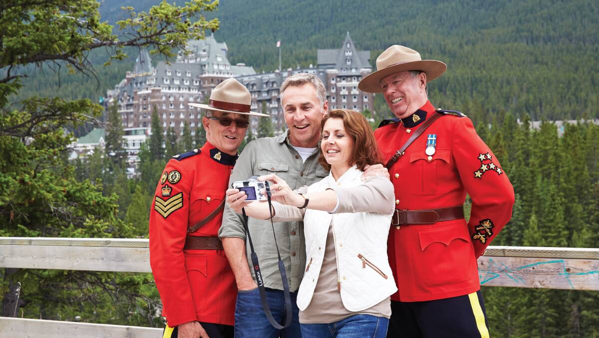 Taking a photo-opportunity with the Royal Canadian Mounted Police, often shortened to Mounties, while staying at the Fairmont Banff Springs.