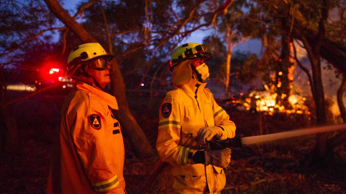 Firefighters at work last week to put out fires at the edge of North Black Range bushfire near Braidwood. Picture: Dion Georgopoulos