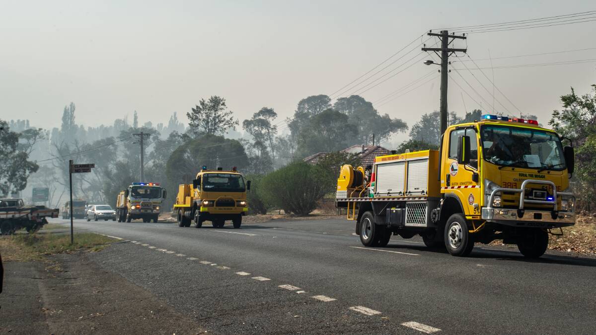 The Queensland Fire Service strike force on the move through Tharwa. Picture: Karleen Minney