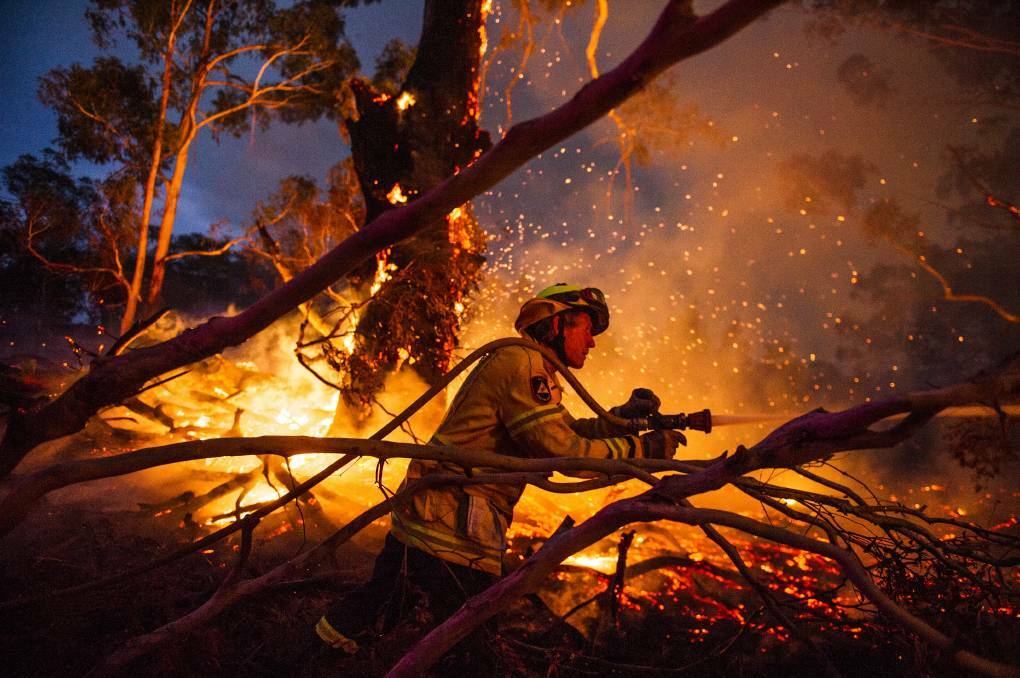 ACT RFS volunteers battling the North Black Range bushfire. Picture: Dion Georgopoulos.