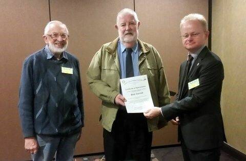 CONGRATULATIONS: Bob Garrett (centre) receives his award from Mark Schipp (right) and Graham Waite.