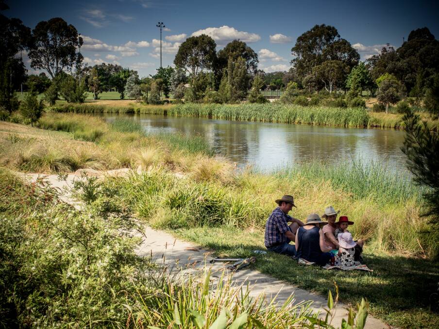 NATURAL SETTING: A family enjoy the Dickson Wetlands, one of the many natural green spaces that residents of Canberra enjoy in their immediate surroundings.