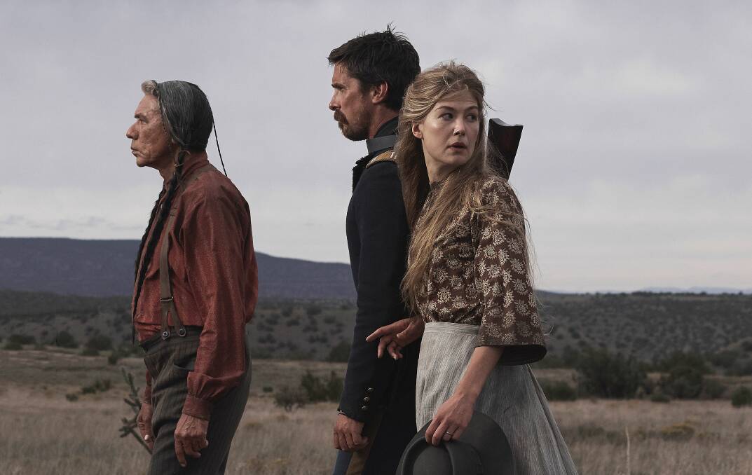 DANGEROUS PLACES: On their journey across America, Yellow Hawk (Wes Studi) and Captain Joe Blocker (Christian Bale) meet Rosalee Quaid (Rosamund Pike), whose family have been killed by Comanches.