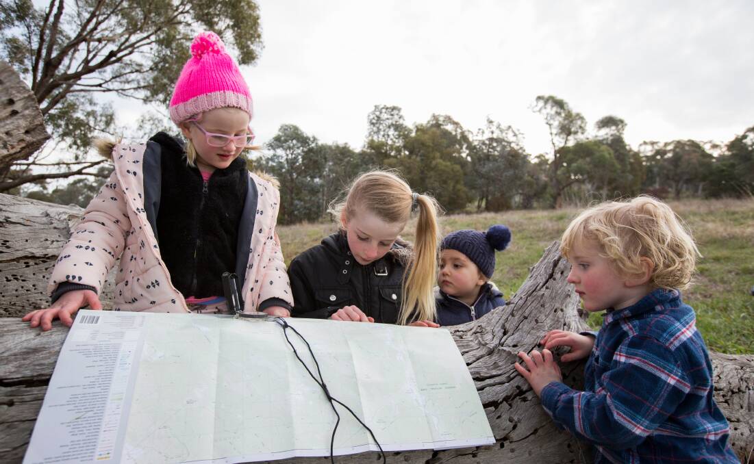 CLEVER KIDS: Jemima Lacey, Molly Lacey, Lucy Dolejsi and Joseph Lacey take part in a mapping activity, one of the many creative ways education can be incorporated into outdoor activities.