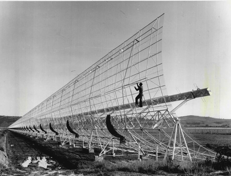 EARLY DAYS: The MOST (then known as the Mills Cross radio-telescope) at its opening in 1965, with a research student climbing the east-west arm.