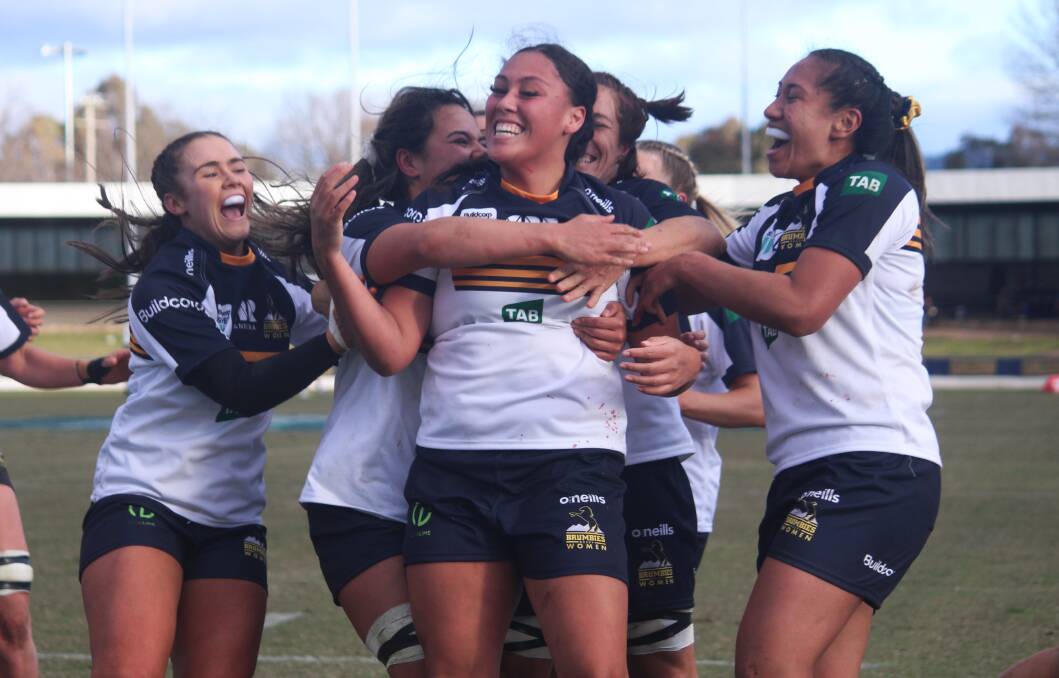 On top: The Brumbies celebrate the first try of the match, which was scored by Zali Waihape-Andrews (centre) in the 30th minute of the game. Photo: Zac Lowe.
