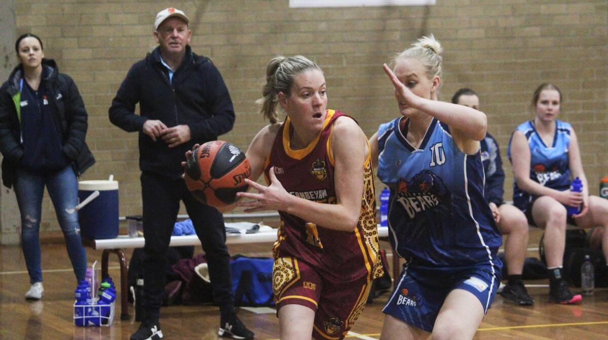 Duck and weave: Queanbeyan's Abbie Davis works her way past Goulburn's Naomi Lucas in the specially-designed Indigenous Round jersey which was worn by all Queanbeyan players on the night. Photo: Zac Lowe.