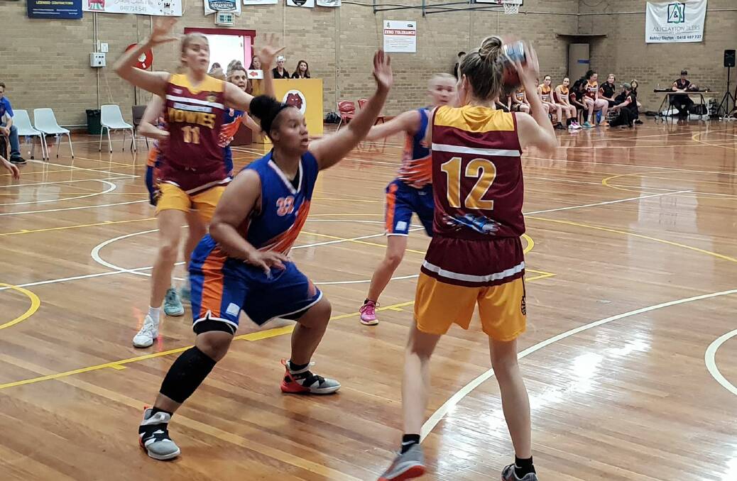 Working around: Queanbeyan's Abbie Davis looks for a way past her Wagga opponent on Saturday night at the Queanbeyan Basketball Stadium, which resulted in a 94-84 victory. Photo: Zac Lowe.