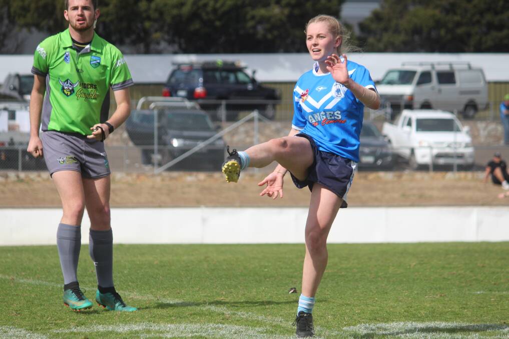 Big kick: Remi Wilton guides a kick over her Goulburn opponents during the Blues' unsuccessful preliminary final against the Stockmen in August, in which they went down 22-32. Photo: Zac Lowe. 