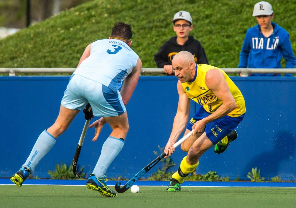 Fancy footwork: Glenn Turner attempts to pass New South Wales' Simon Orchard during the Lakers' 3-1 victory on Saturday at the ACT Hockey Centre, which confirmed a finals spot for the home side. Photo: Click InFocus.