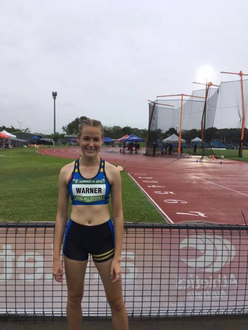 Wet and windy: Laura Warner stands in front of the arena during the Australian All Schools Championships in Cairns, which was held from December 7 to December 9. Photo: Queanbeyan Athletics Club. 