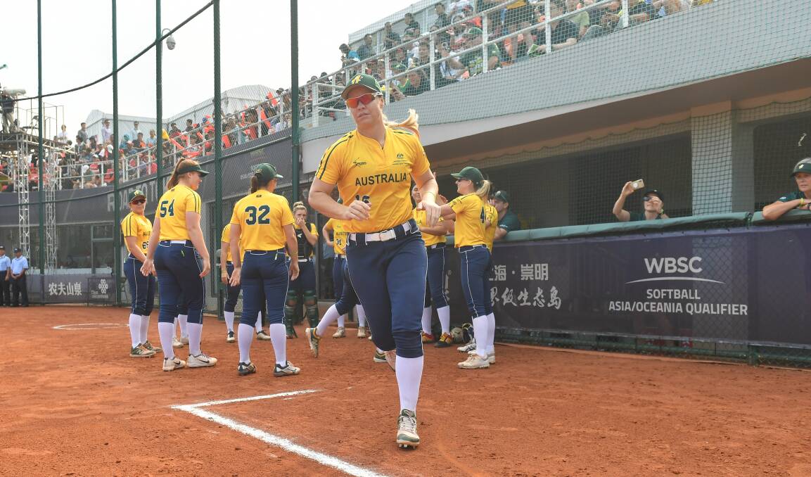 Tokyo bound: It was mission accomplished for Stacey Porter, here leading Australia out, and her Aussie Spirit side as they secured an Olympic berth. Photo: WBSC