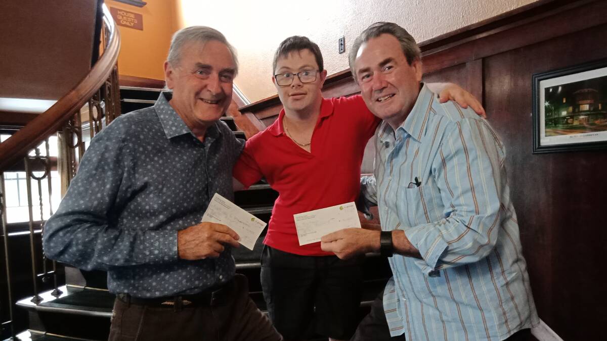 Kyle Burnell (centre) presents a cheque to Bill Baker from the Treehouse, left, and Paul Walshe from Respite Care for Queanbeyan.