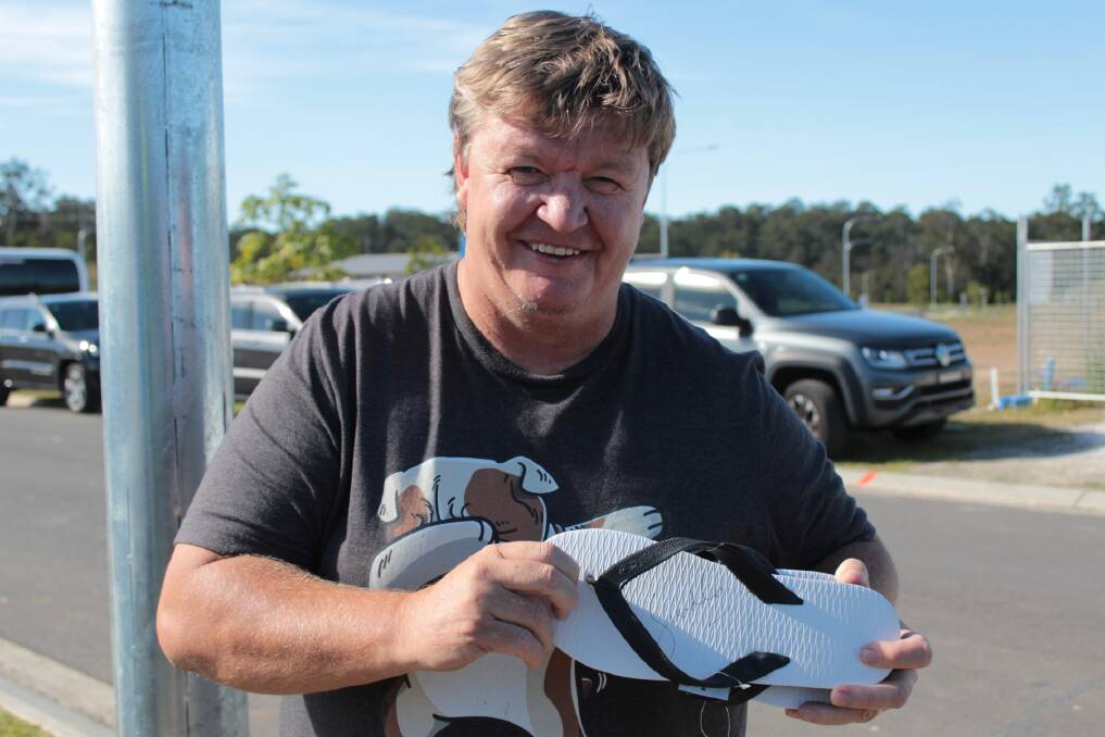 Legend: Harry Harris of Port Macquarie with his thongs signed by Prime Minister Scott Morrision. Photo: Tracey Fairhurst.