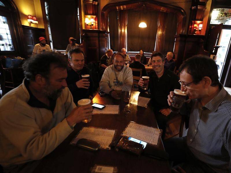 Drinks have been raised in toasts as people in parts of the UK were allowed to meet in pubs again.