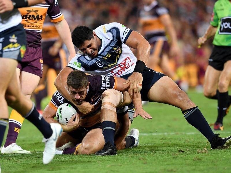 Cowboys lock Jason Taumalolo (right) suffered a knee injury in the NRL clash with Brisbane.